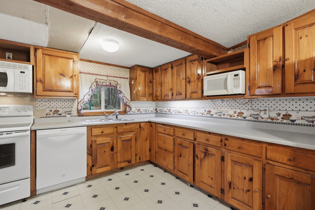 987 Patriots Road Templeton, MA 01468 - Photo 13 of 39 a kitchen with sink cabinets and window