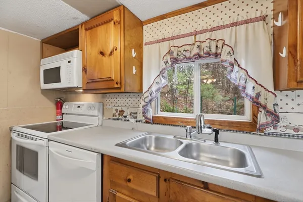 a kitchen with a sink cabinets and a wooden floor