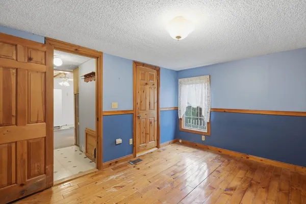 an empty room with windows and closet