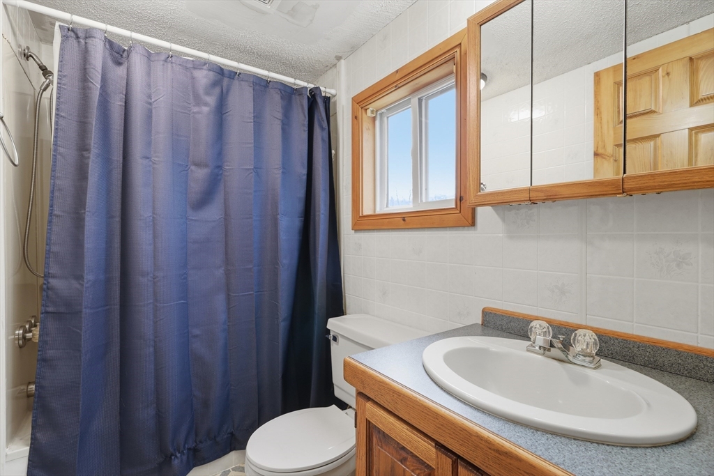987 Patriots Road Templeton, MA 01468 - Photo 29 of 39 a bathroom with a sink a toilet and a mirror