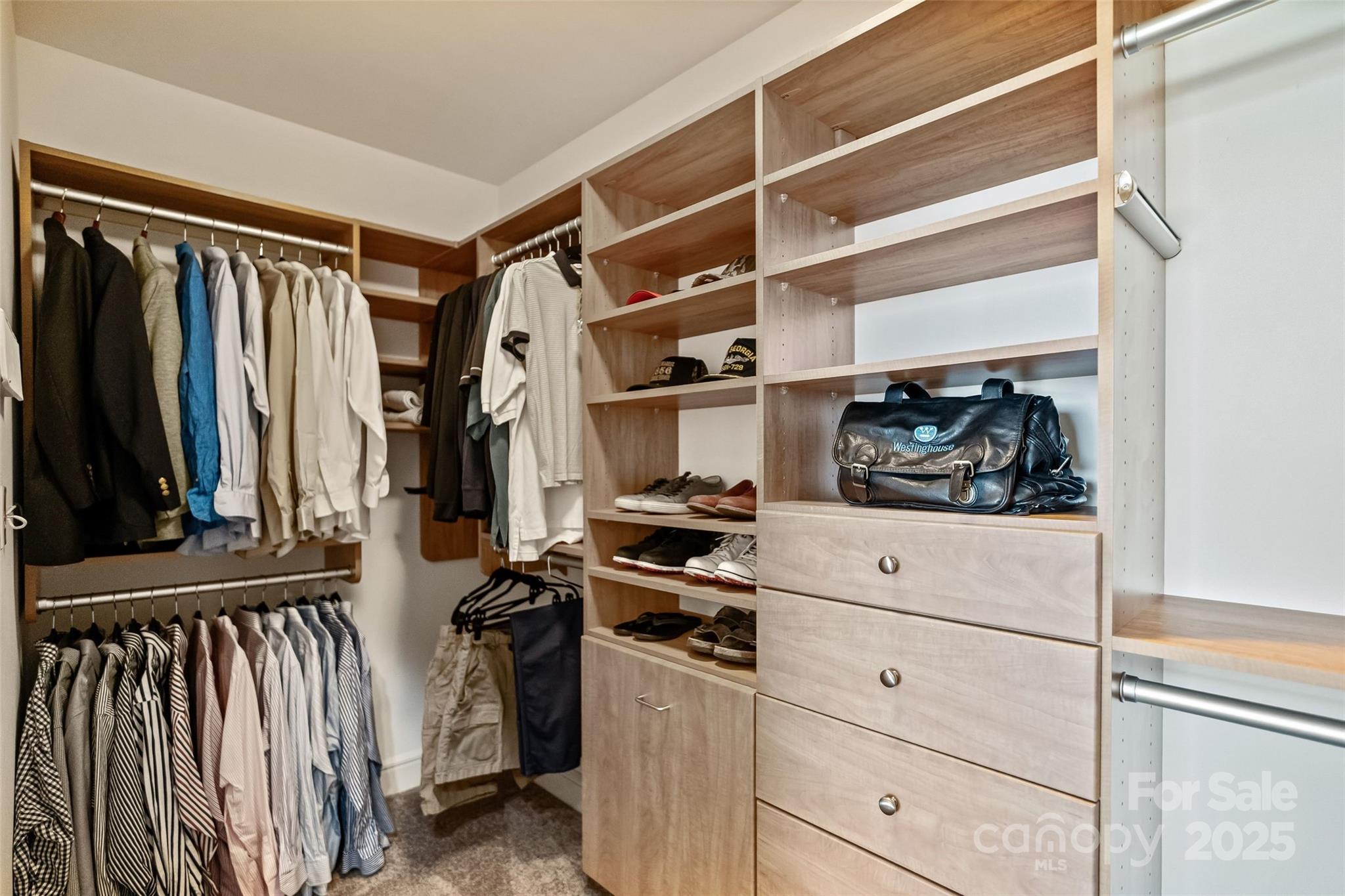 333 West Trade Street, Unit 1301 Charlotte, NC 28202 - Photo 17 of 34 a view of walk in closet with clothes and shoes