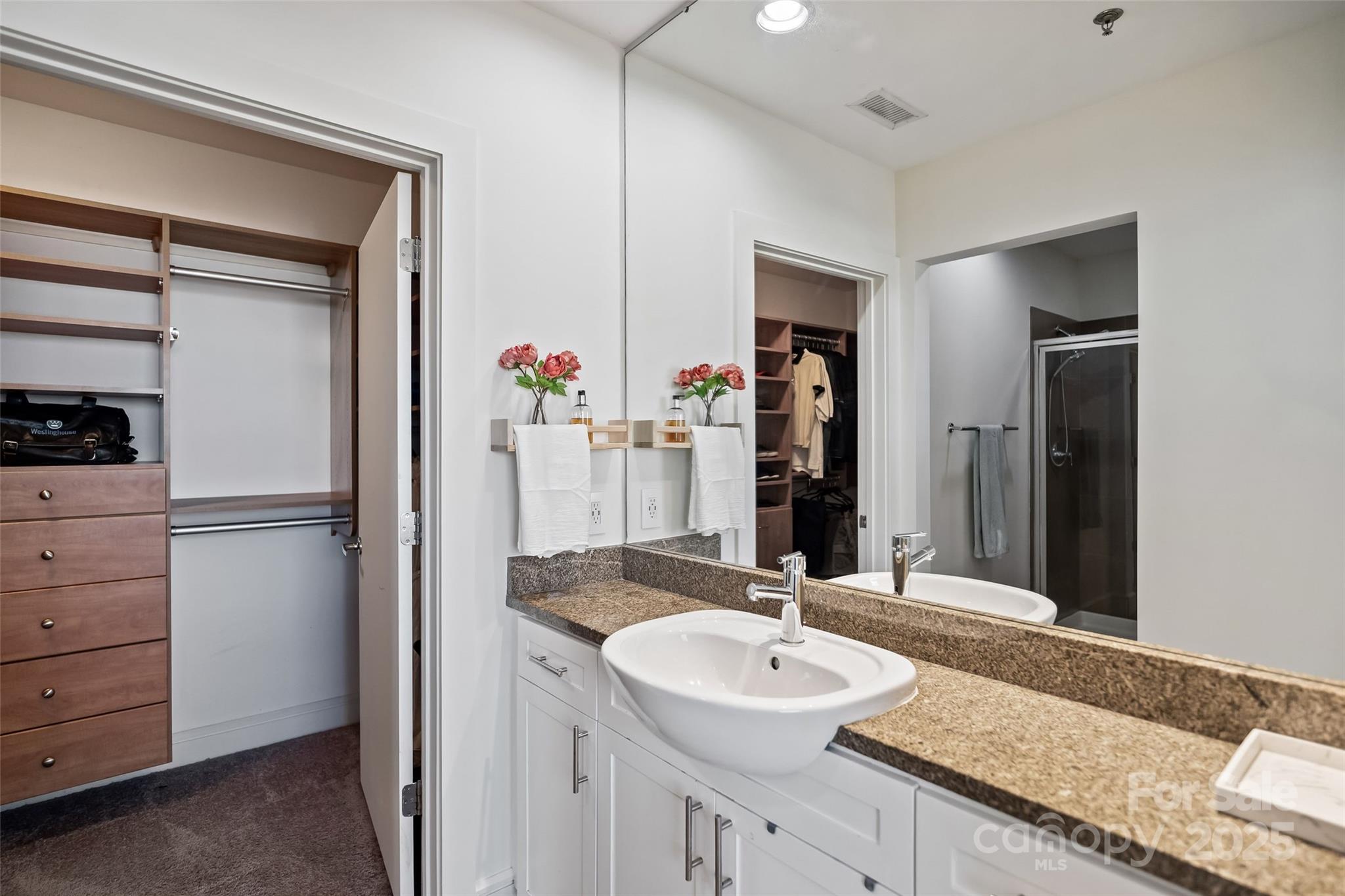 333 West Trade Street, Unit 1301 Charlotte, NC 28202 - Photo 18 of 34 a bathroom with a granite countertop sink and a mirror