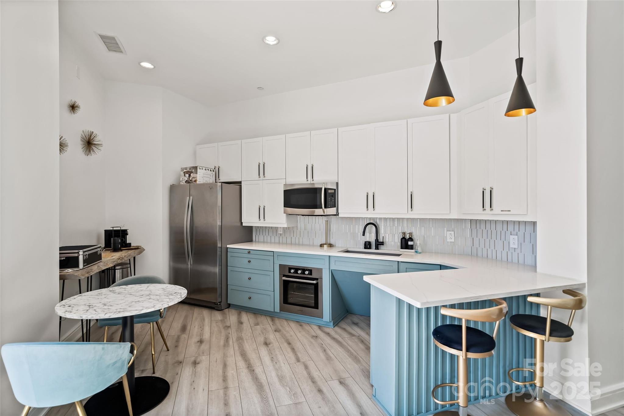 333 West Trade Street, Unit 1301 Charlotte, NC 28202 - Photo 34 of 34 a kitchen with stainless steel appliances a sink a stove a refrigerator and cabinets