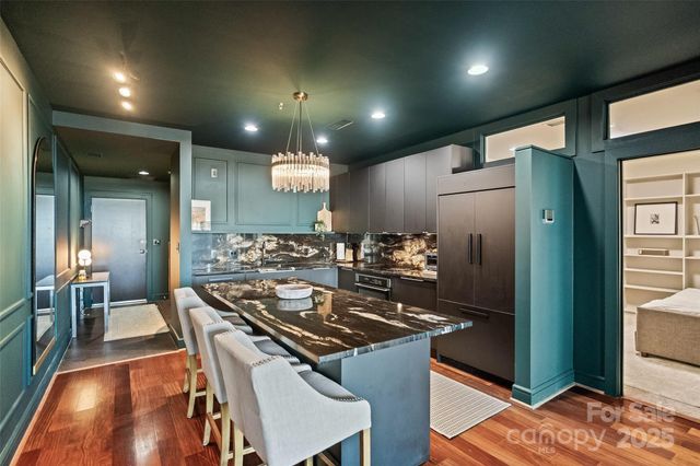 a kitchen with stainless steel appliances granite countertop a stove and a refrigerator