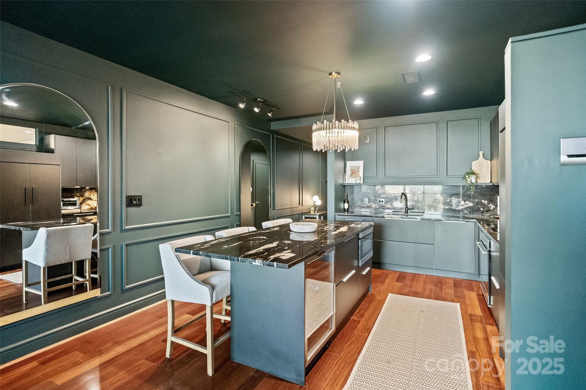 333 West Trade Street, Unit 1301 Charlotte, NC 28202 - Photo 6 of 34 a kitchen with stainless steel appliances kitchen island granite countertop a stove a sink and a refrigerator