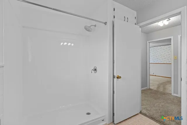 a bathroom with a glass shower door