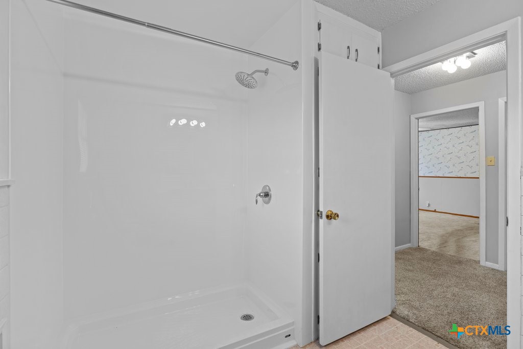 2014 South 47th Street Temple, TX 76504 - Photo 5 of 11 a bathroom with a glass shower door