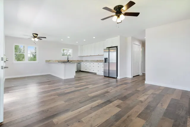 a view of a kitchen with a sink cabinets and wooden floor
