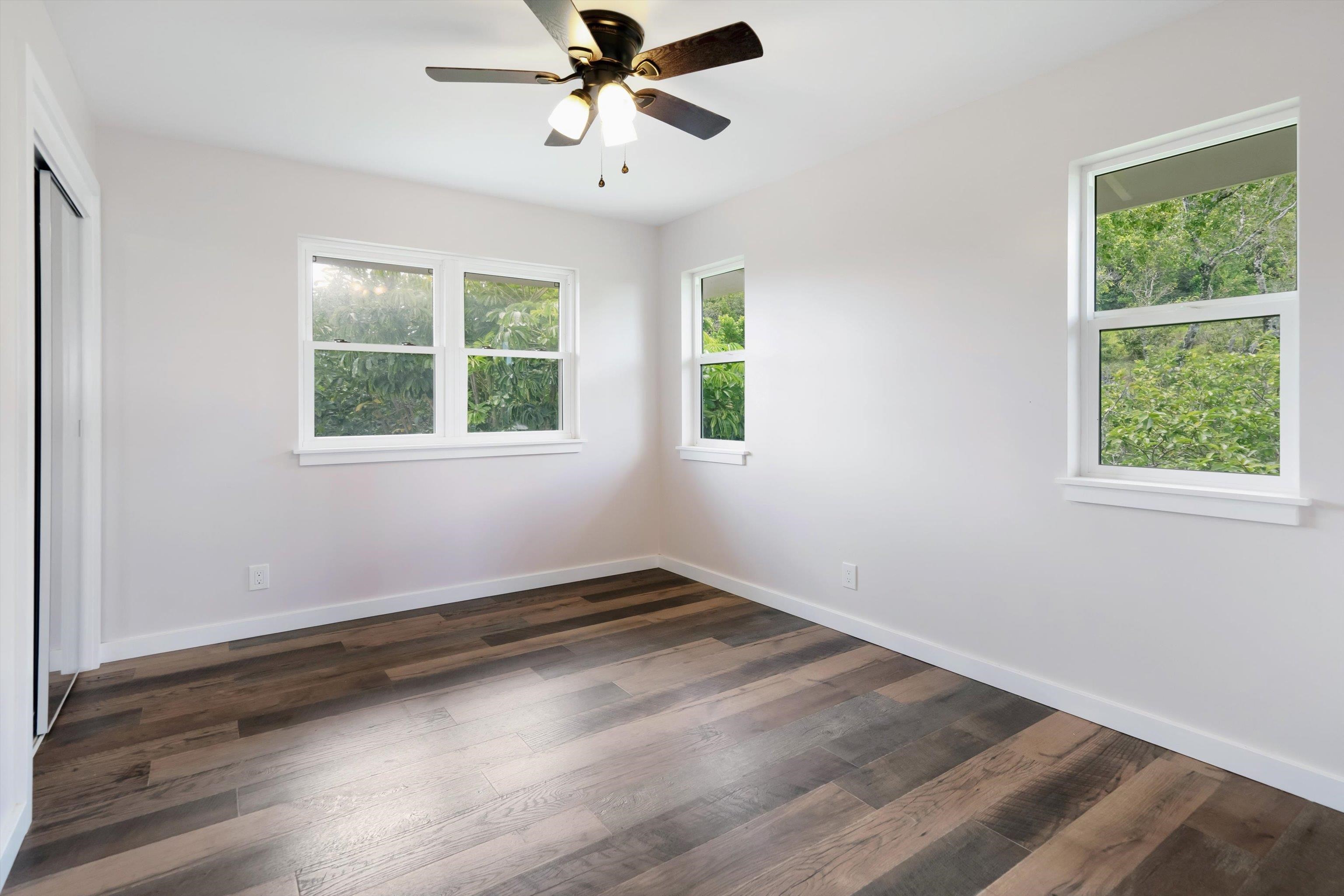 605 Kaupakalua Road Haiku, HI 96708 - Photo 15 of 44 a view of an empty room with wooden floor and window