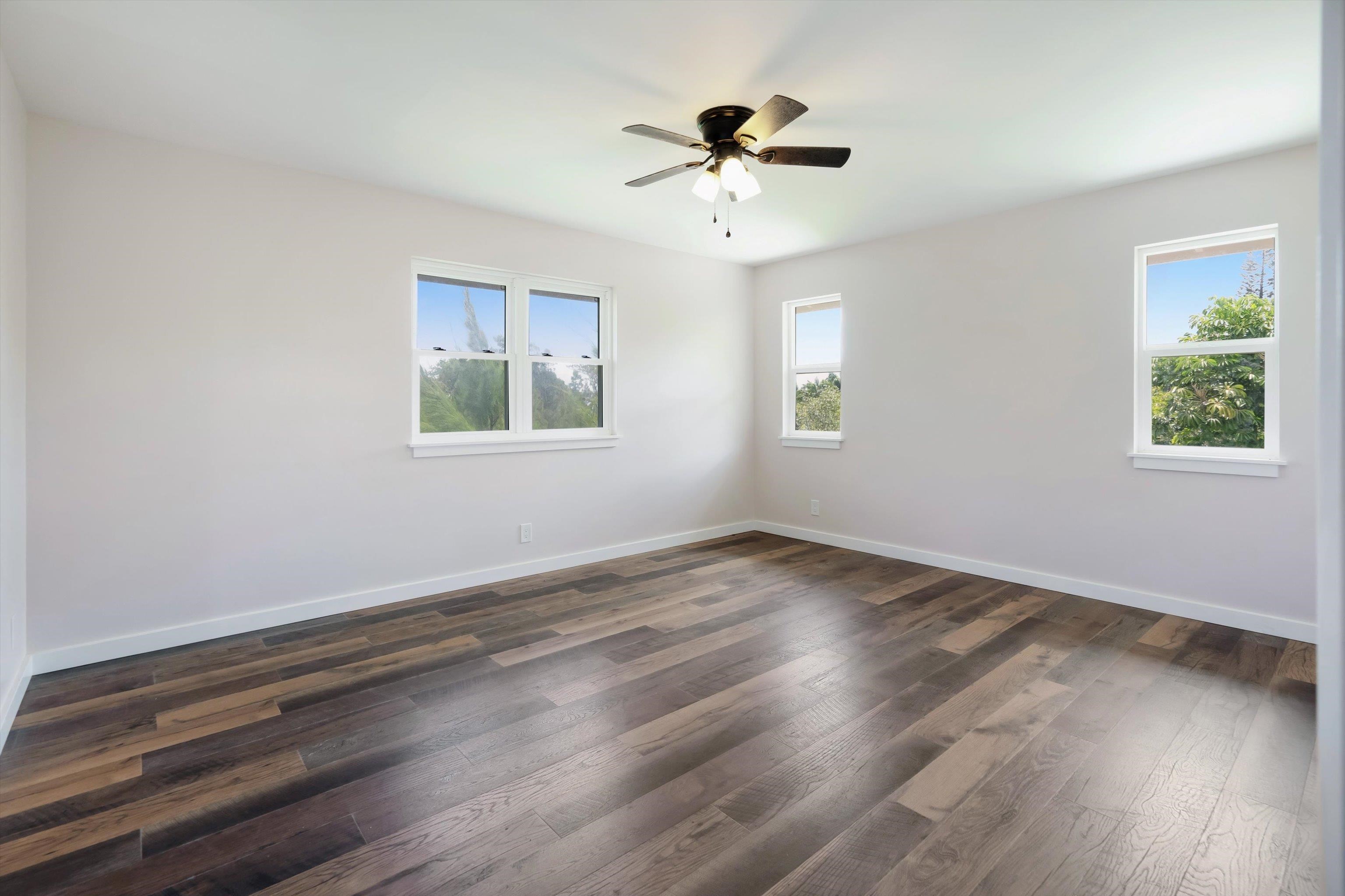 605 Kaupakalua Road Haiku, HI 96708 - Photo 17 of 44 a view of an empty room with wooden floor and a window