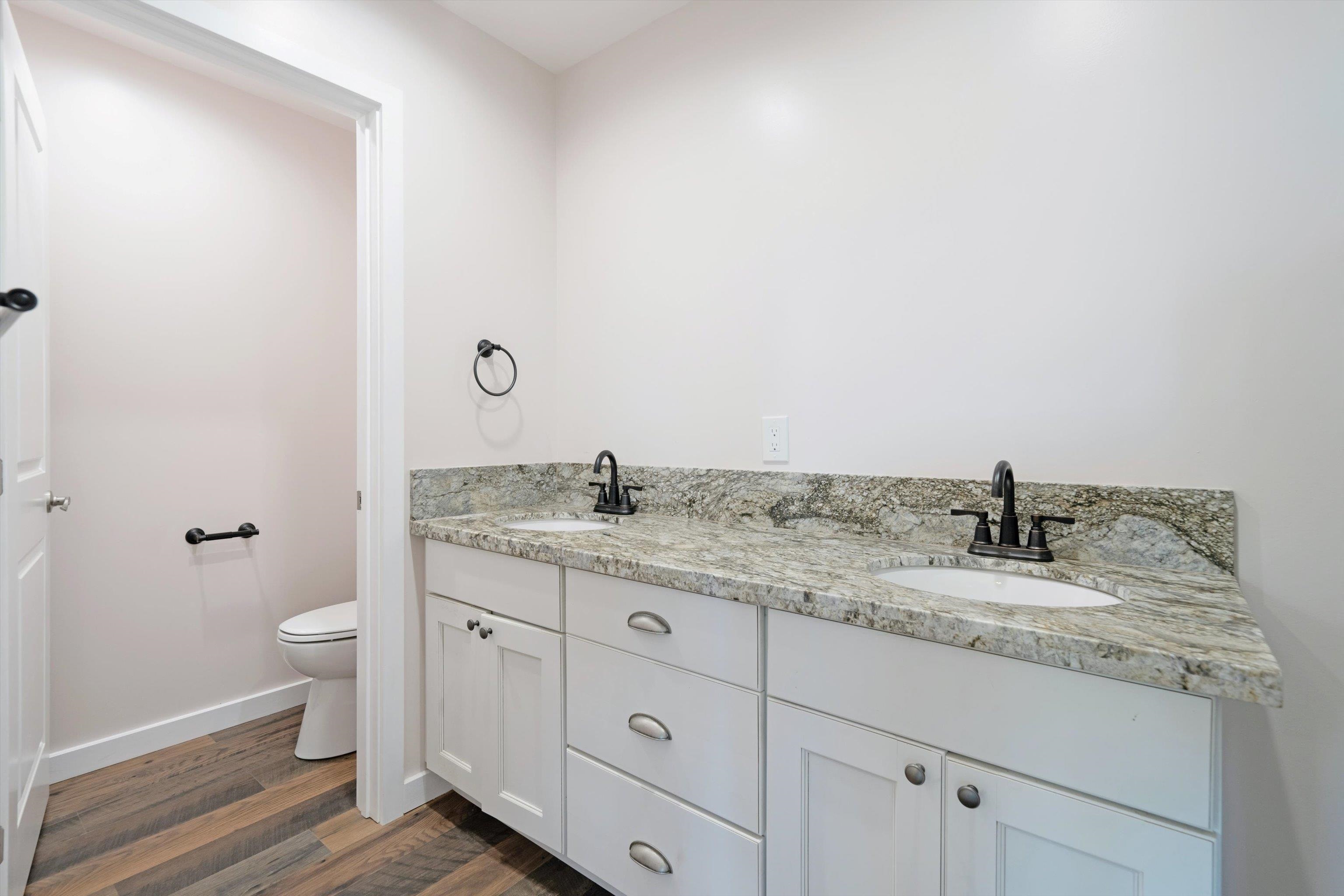 605 Kaupakalua Road Haiku, HI 96708 - Photo 21 of 44 a bathroom with a granite countertop sink and a toilet
