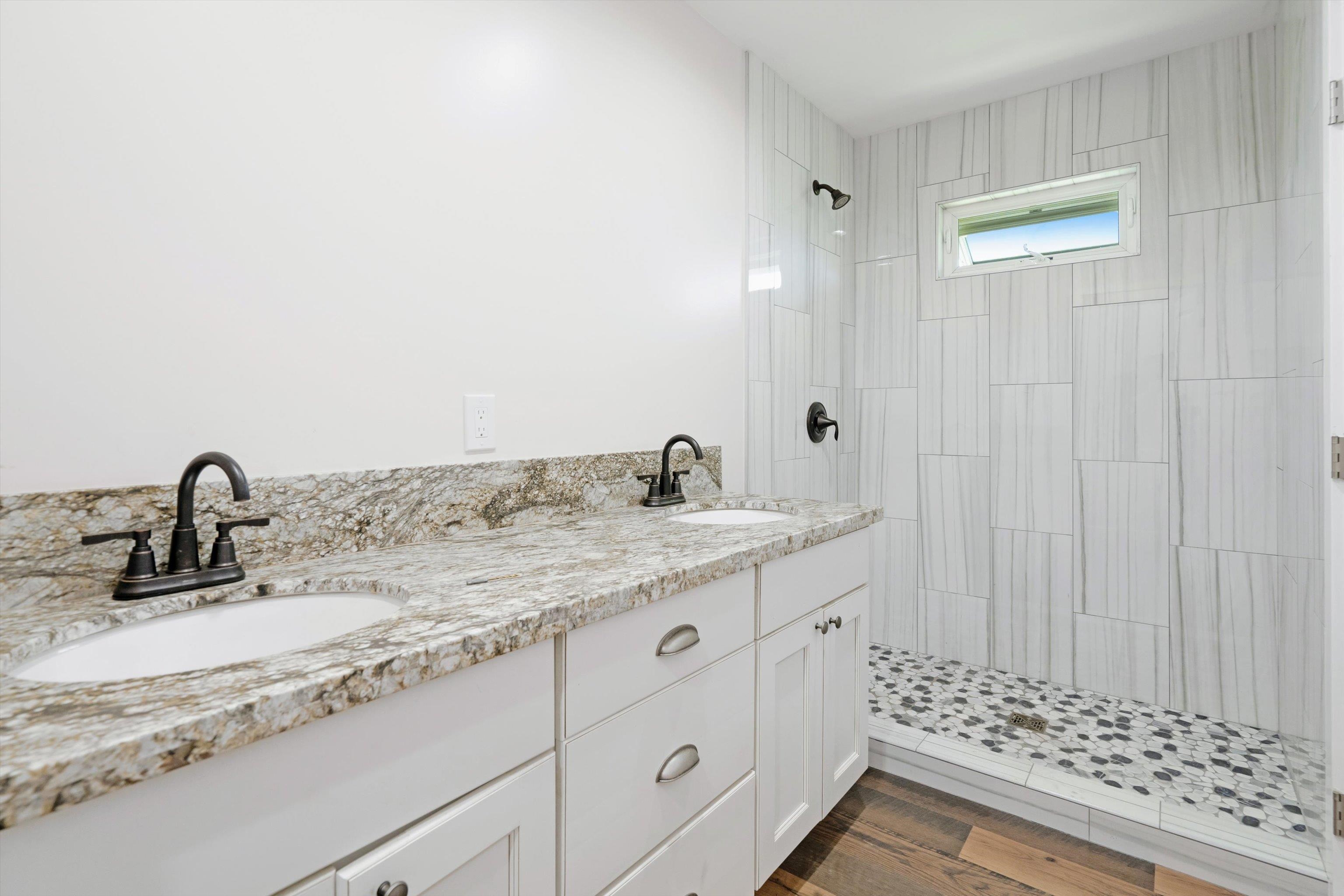 605 Kaupakalua Road Haiku, HI 96708 - Photo 22 of 44 a bathroom with a granite countertop sink and a mirror