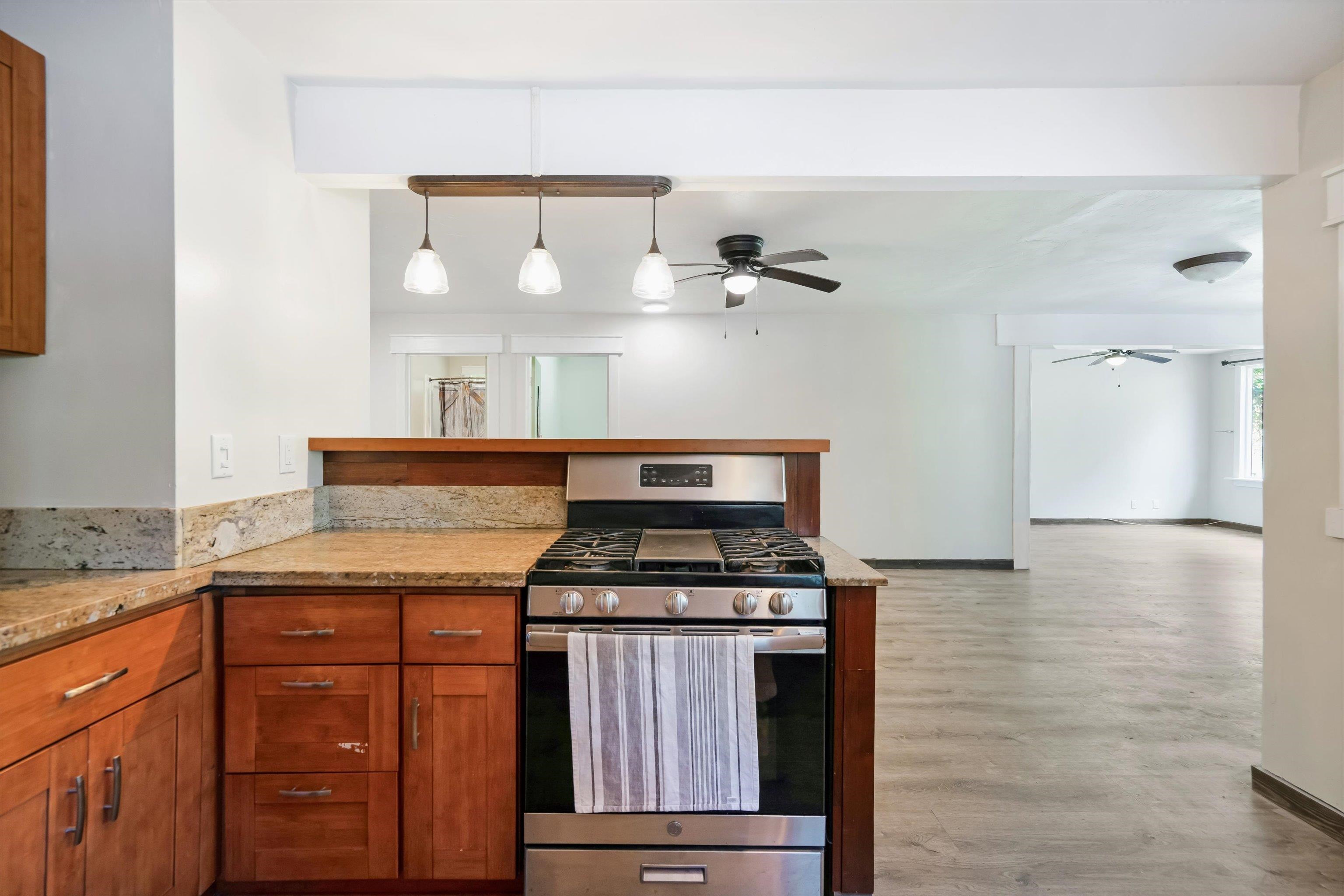 605 Kaupakalua Road Haiku, HI 96708 - Photo 35 of 44 a kitchen with granite countertop a stove and a sink