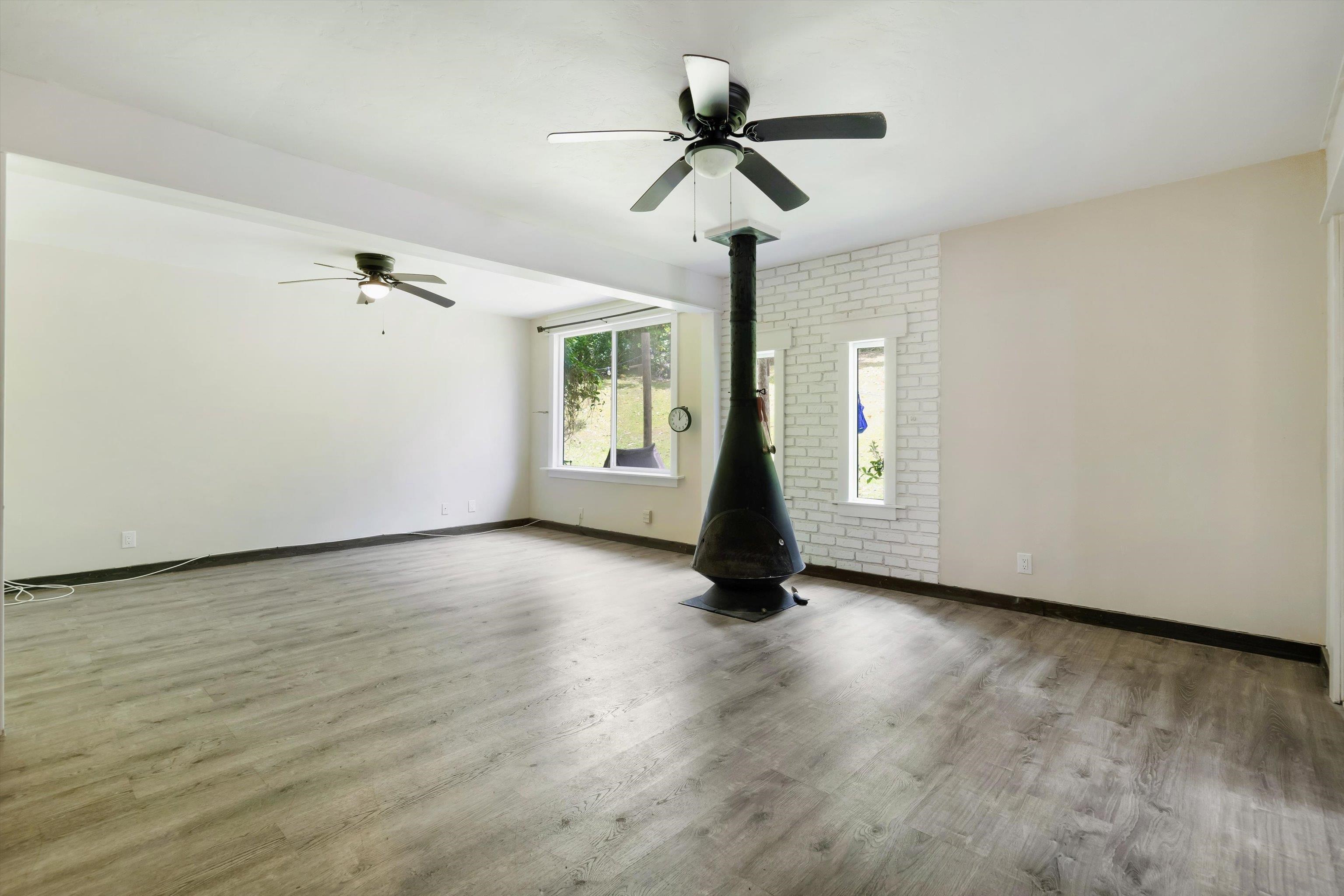 605 Kaupakalua Road Haiku, HI 96708 - Photo 37 of 44 a view of an empty room with a window and wooden floor