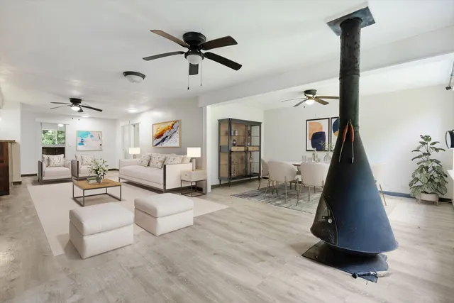 a living room with furniture and a ceiling fan