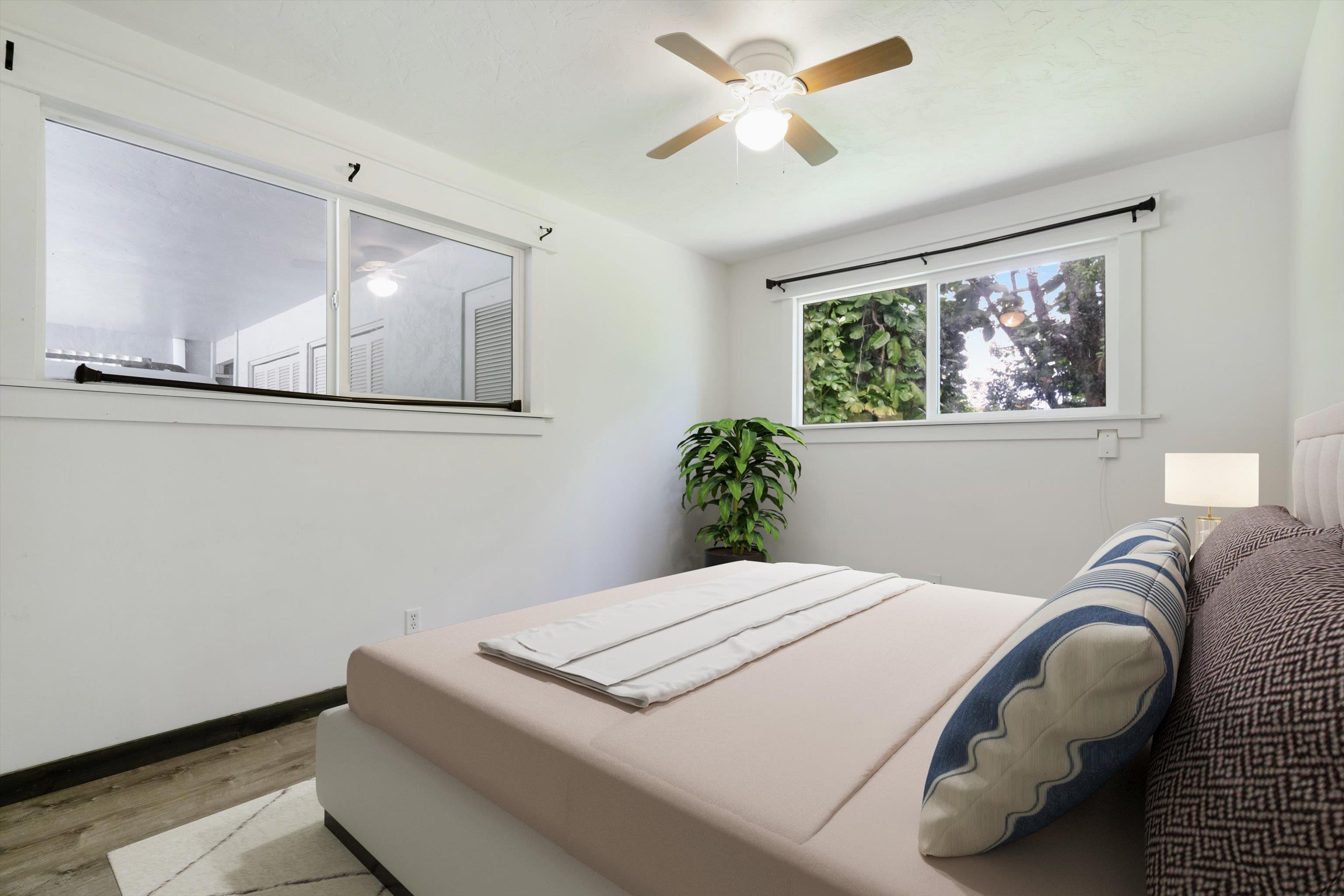 605 Kaupakalua Road Haiku, HI 96708 - Photo 43 of 44 a bedroom with a bed and a painting on the wall
