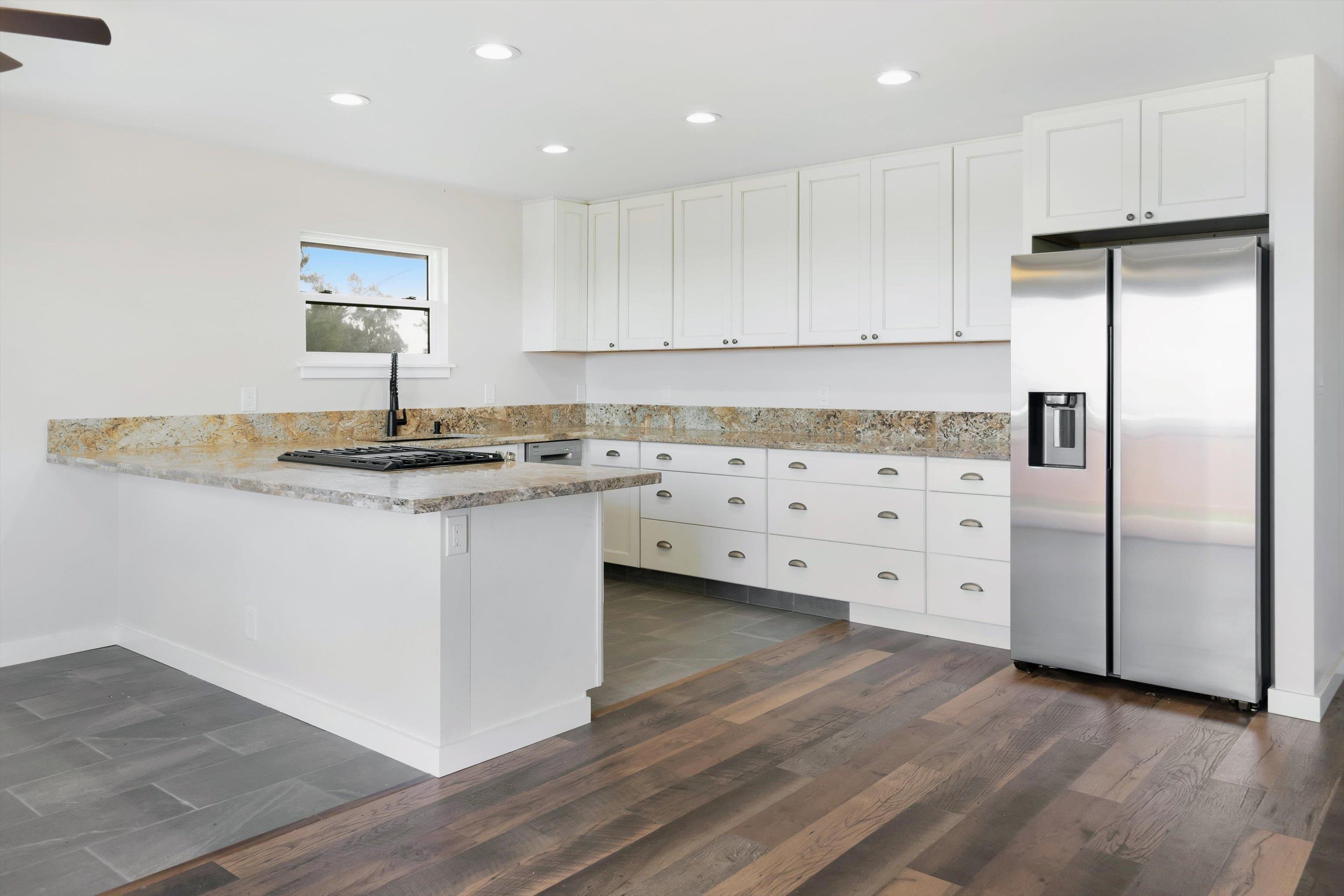 605 Kaupakalua Road Haiku, HI 96708 - Photo 5 of 44 a kitchen with white cabinets sink and refrigerator