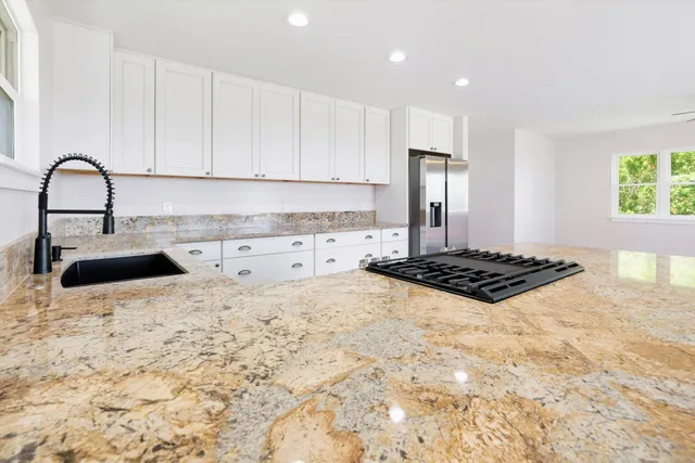 a kitchen with a stove a sink and a refrigerator