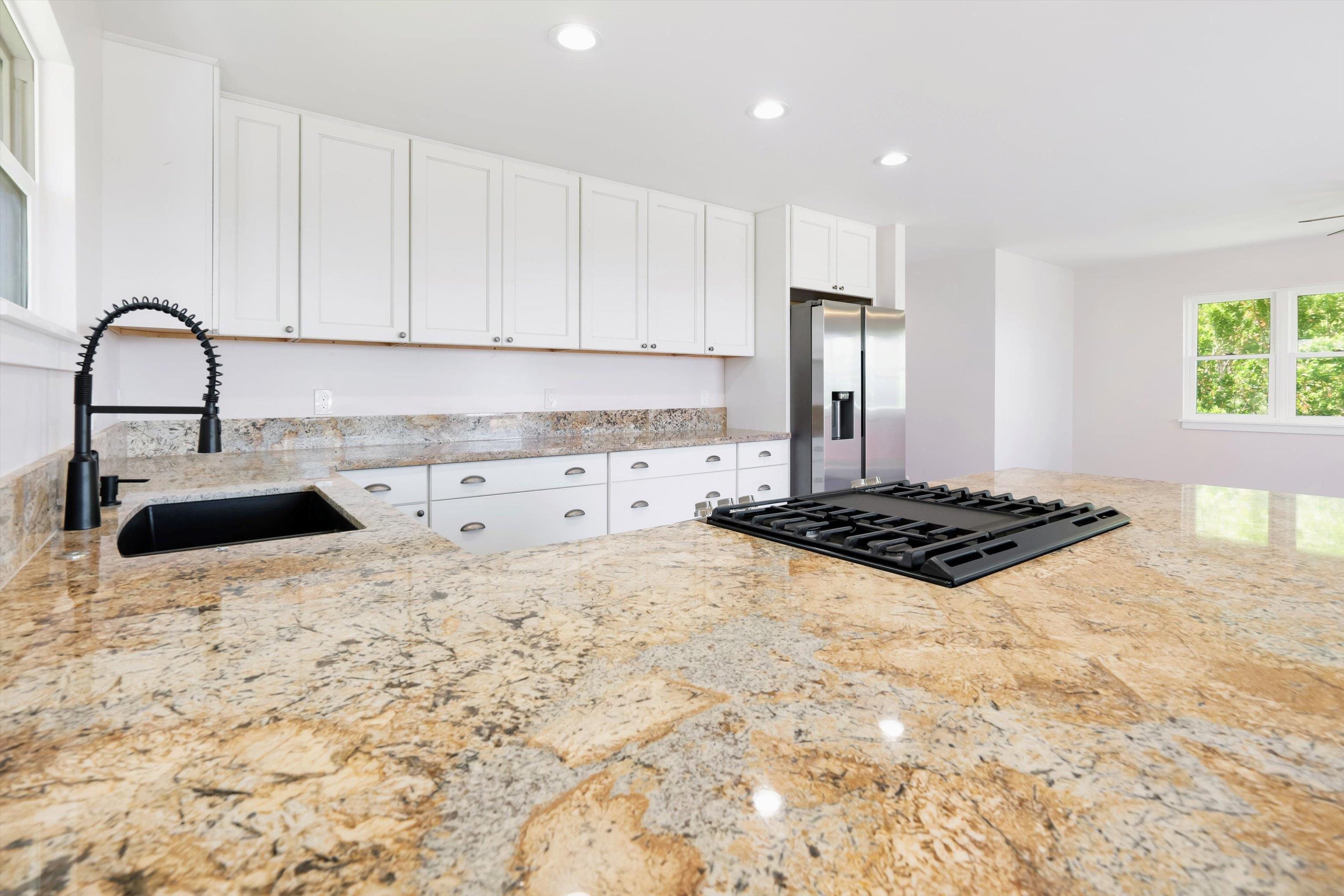 605 Kaupakalua Road Haiku, HI 96708 - Photo 8 of 44 a kitchen with a stove a sink and a refrigerator