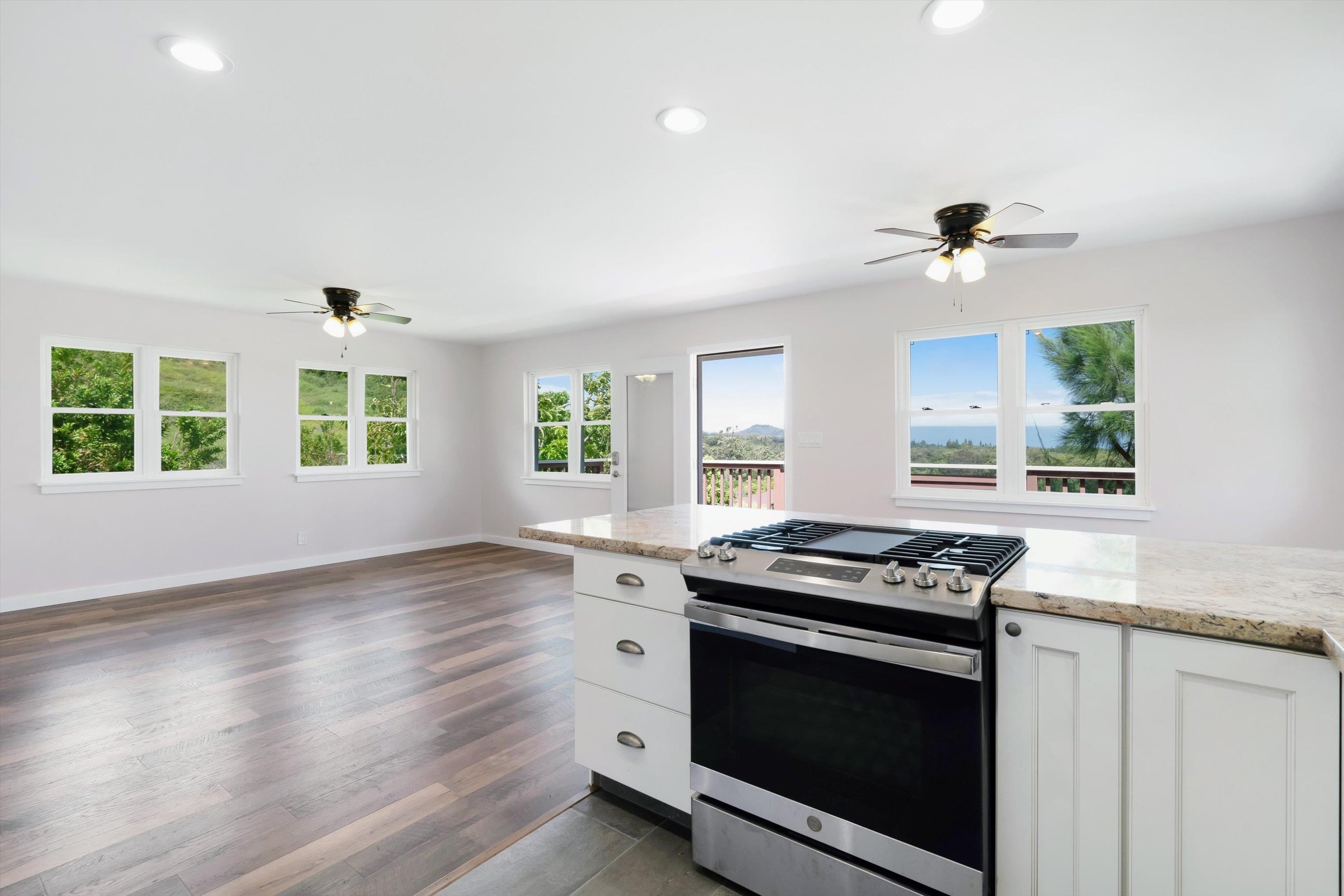 605 Kaupakalua Road Haiku, HI 96708 - Photo 9 of 44 a kitchen with granite countertop a stove and a sink
