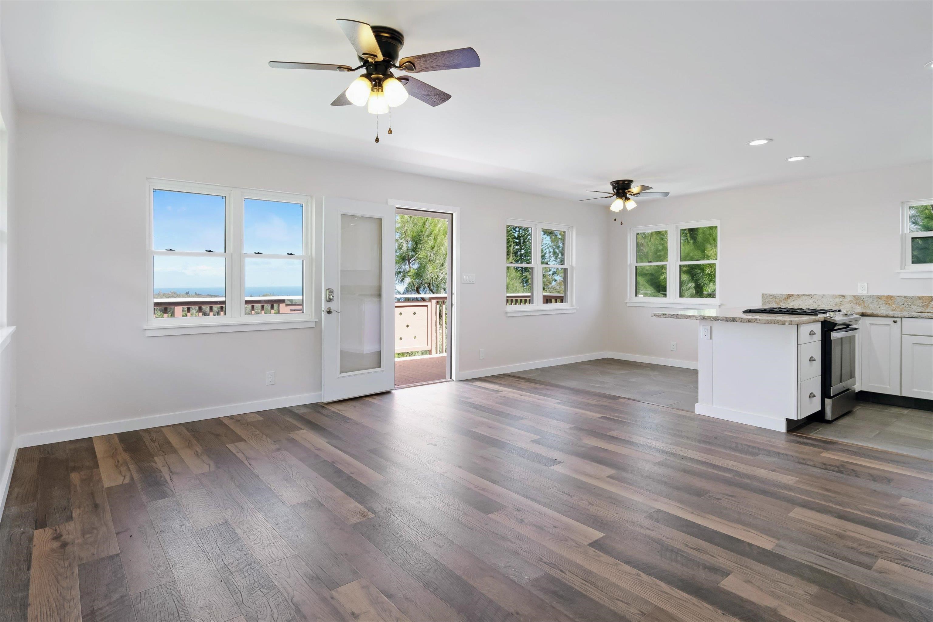605 Kaupakalua Road Haiku, HI 96708 - Photo 10 of 44 a view of an empty room with window and wooden floor