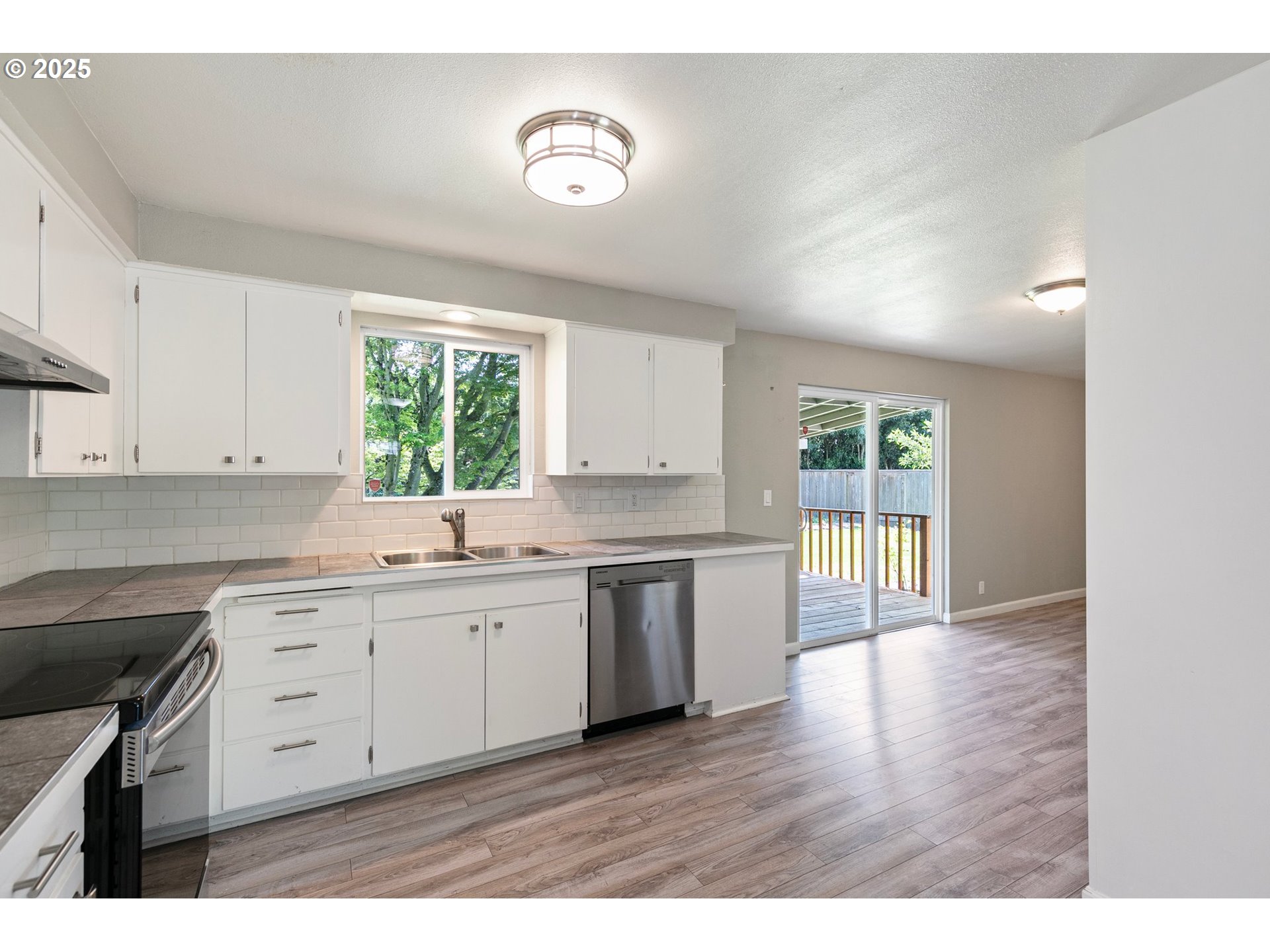 620 Nottingham Avenue Eugene, OR 97404 - Photo 12 of 36 a kitchen with granite countertop a stove top oven sink and cabinets
