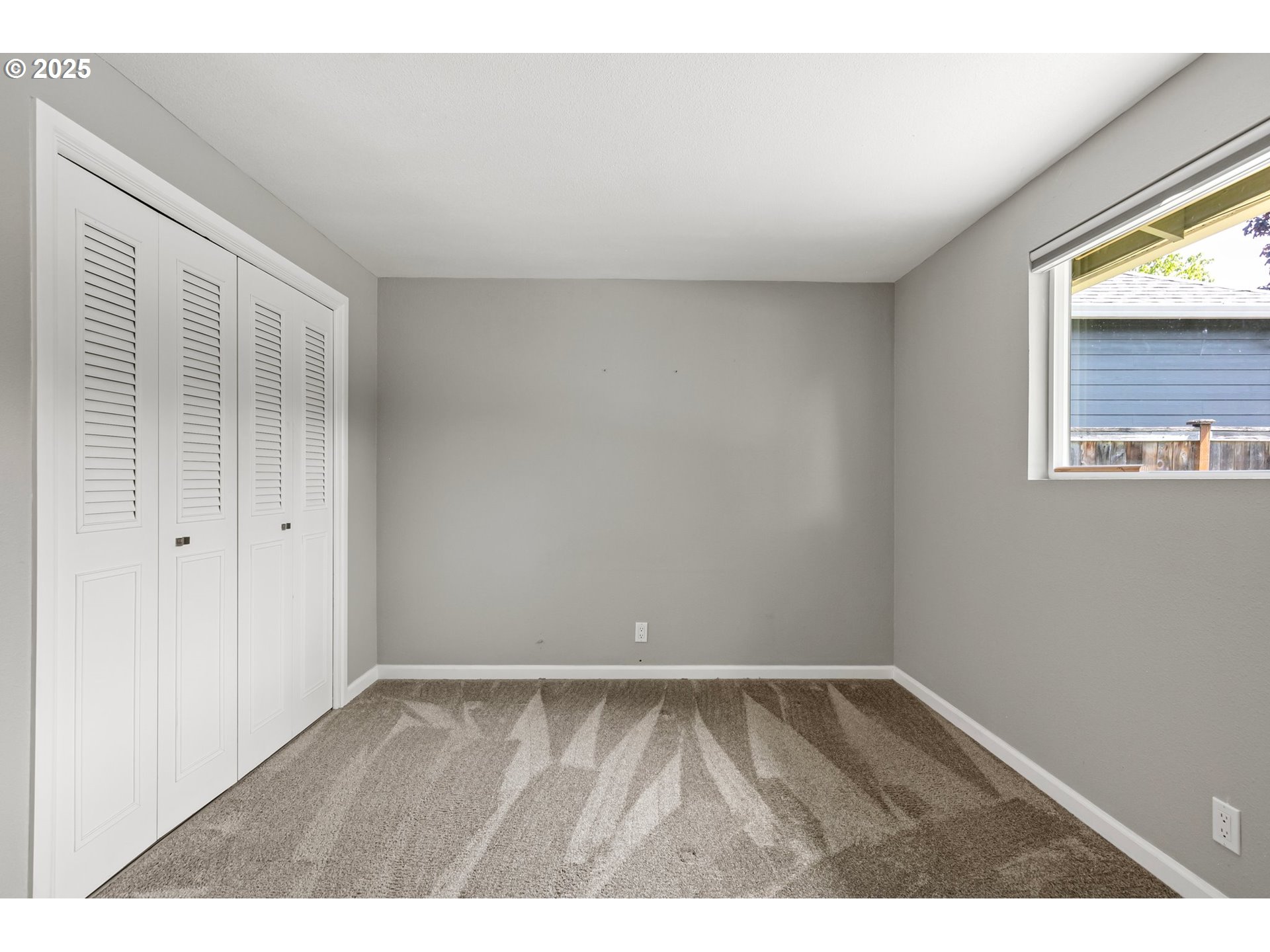 620 Nottingham Avenue Eugene, OR 97404 - Photo 19 of 36 a view of an empty room with wooden floor and a window