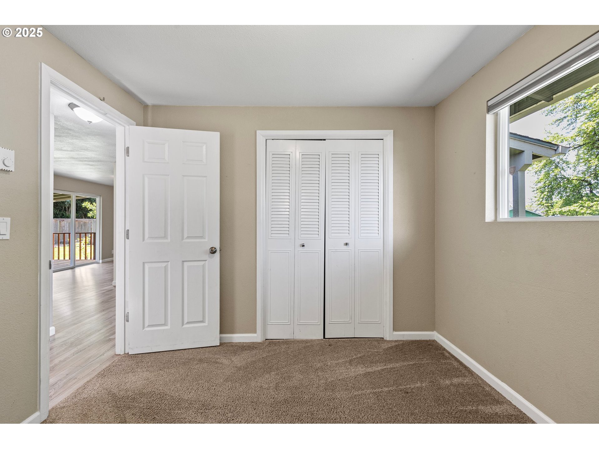 620 Nottingham Avenue Eugene, OR 97404 - Photo 27 of 36 a view of an empty room with window and wooden floor