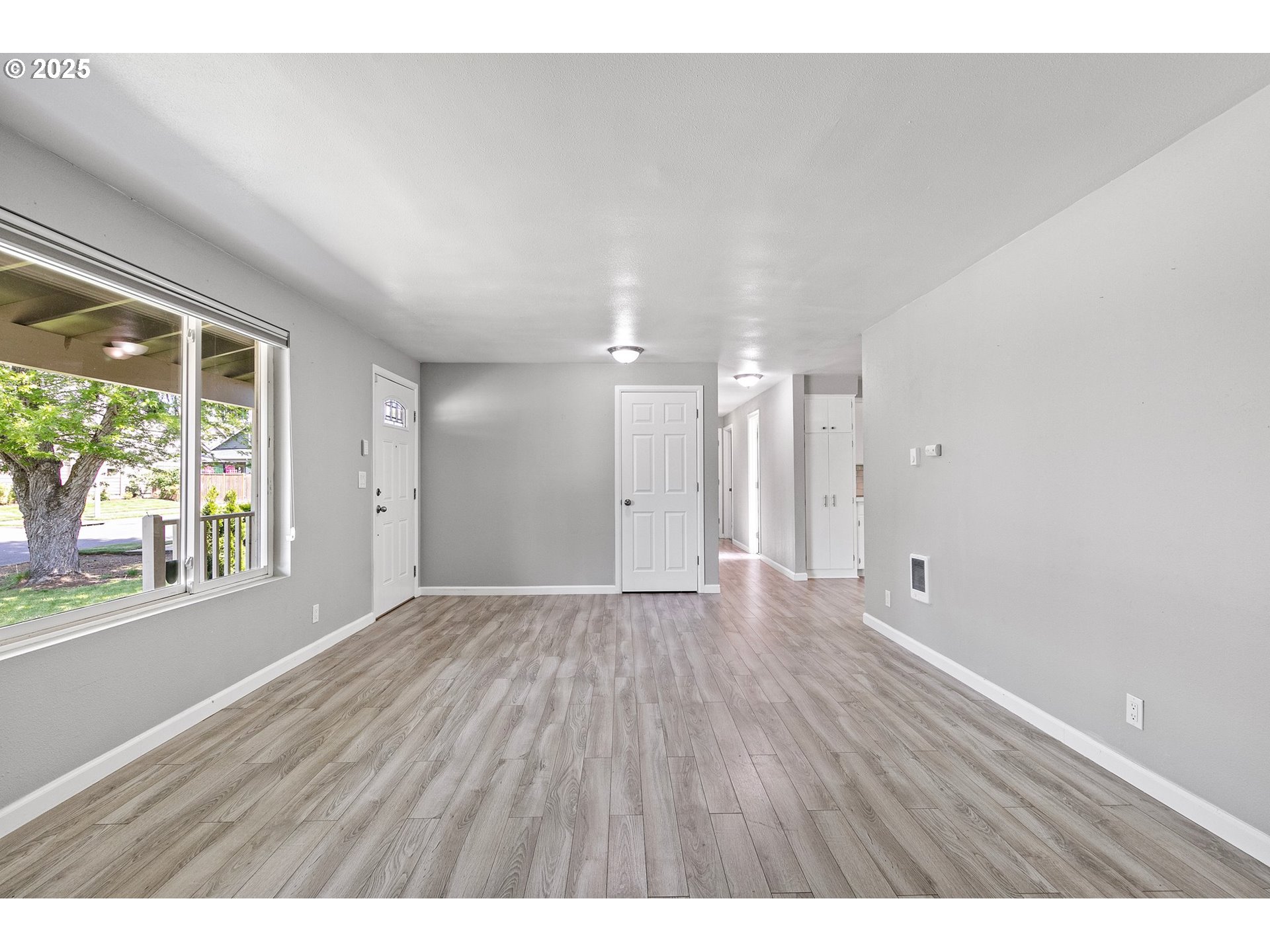 620 Nottingham Avenue Eugene, OR 97404 - Photo 6 of 36 a view of an empty room with wooden floor and a window