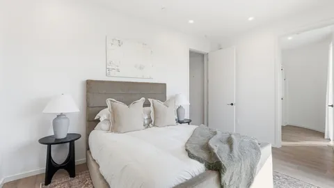 a bedroom with a bed and a night stand