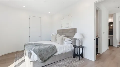 a bedroom with a bed and a night stand