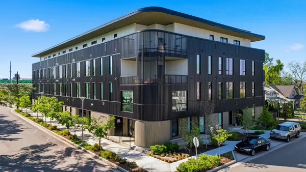 a front view of a building with garden