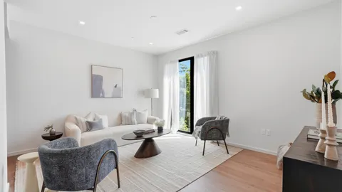 a living room with furniture and a potted plant