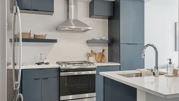 a kitchen with stainless steel appliances a sink stove and cabinets
