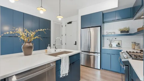 a kitchen with stainless steel appliances a refrigerator and a sink