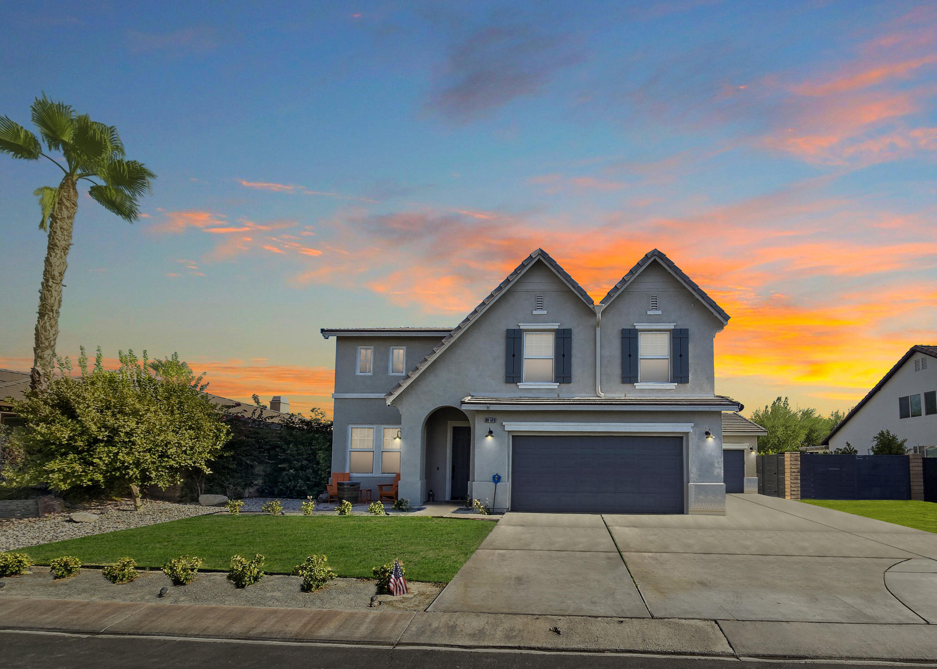 80501 Denton Drive Indio, CA 92203 - Photo 42 of 42 a front view of a house with a yard and garage