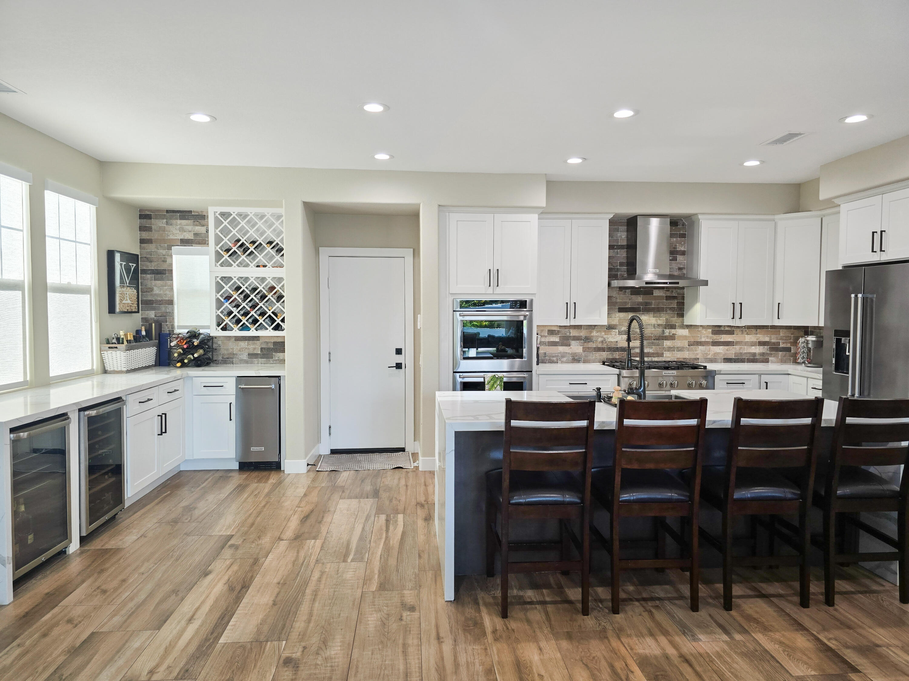 80501 Denton Drive Indio, CA 92203 - Photo 9 of 42 a kitchen with stainless steel appliances kitchen island granite countertop a table chairs microwave and cabinets