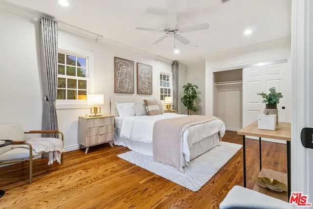 a bedroom with a bed and large window
