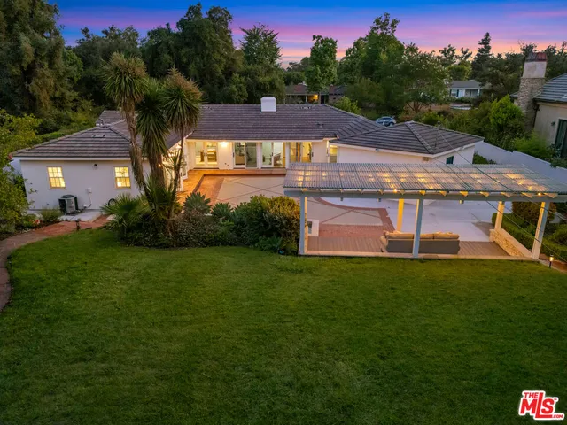 a view of a patio with table and chairs potted plants with wooden floor