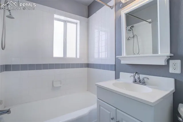 a bathroom with a sink a mirror and a bathtub