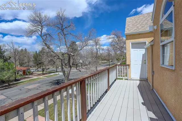 a view of a yard with wooden fence
