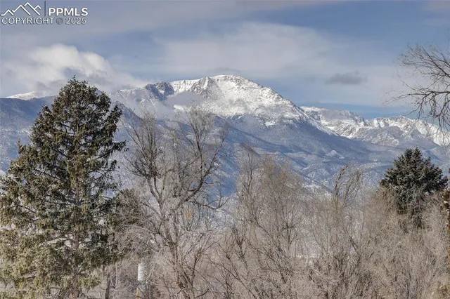 a bathroom with a granite countertop sink a mirror and a shower