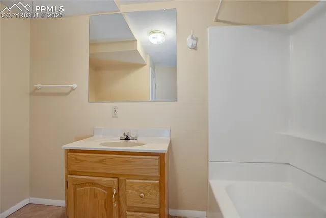 a view of a house with a yard covered in snow