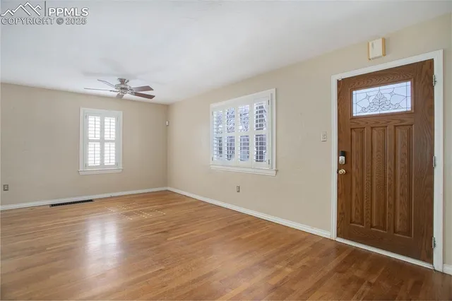 an empty room with windows and closet