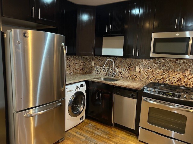 225 East 111th Street, Unit 3B Manhattan, NY 10029 - Photo 3 of 5 a kitchen with stainless steel appliances granite countertop a refrigerator and a stove top oven