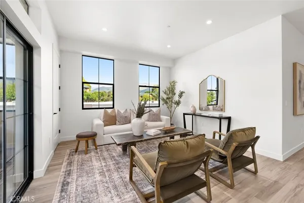 a kitchen with stainless steel appliances a table chairs refrigerator and sink