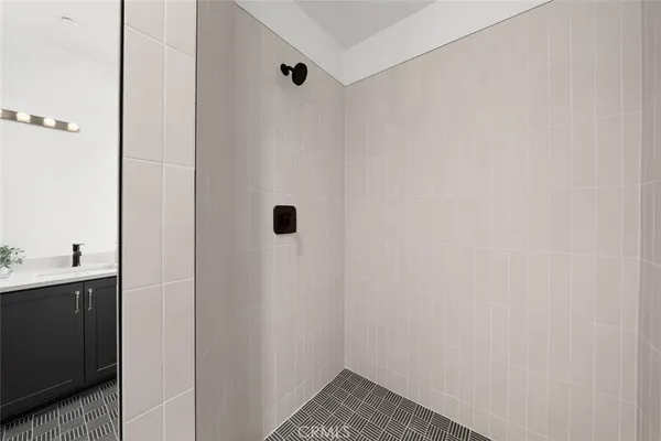 a bathroom with a sink toilet vanity and shower