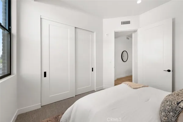 a living room with furniture a table and kitchen view