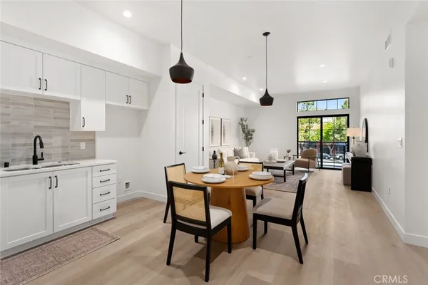 a kitchen with stainless steel appliances granite countertop a sink a stove and a refrigerator