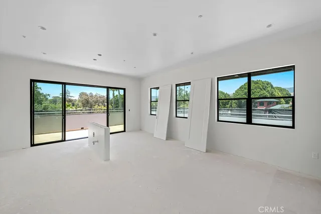 a view of balcony with floor to ceiling windows with wooden floor